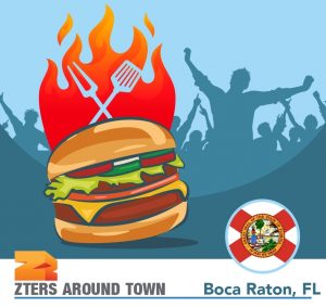 Boca Burger Battle's iconic burger on fire is in the front. A crowd of people is behind.