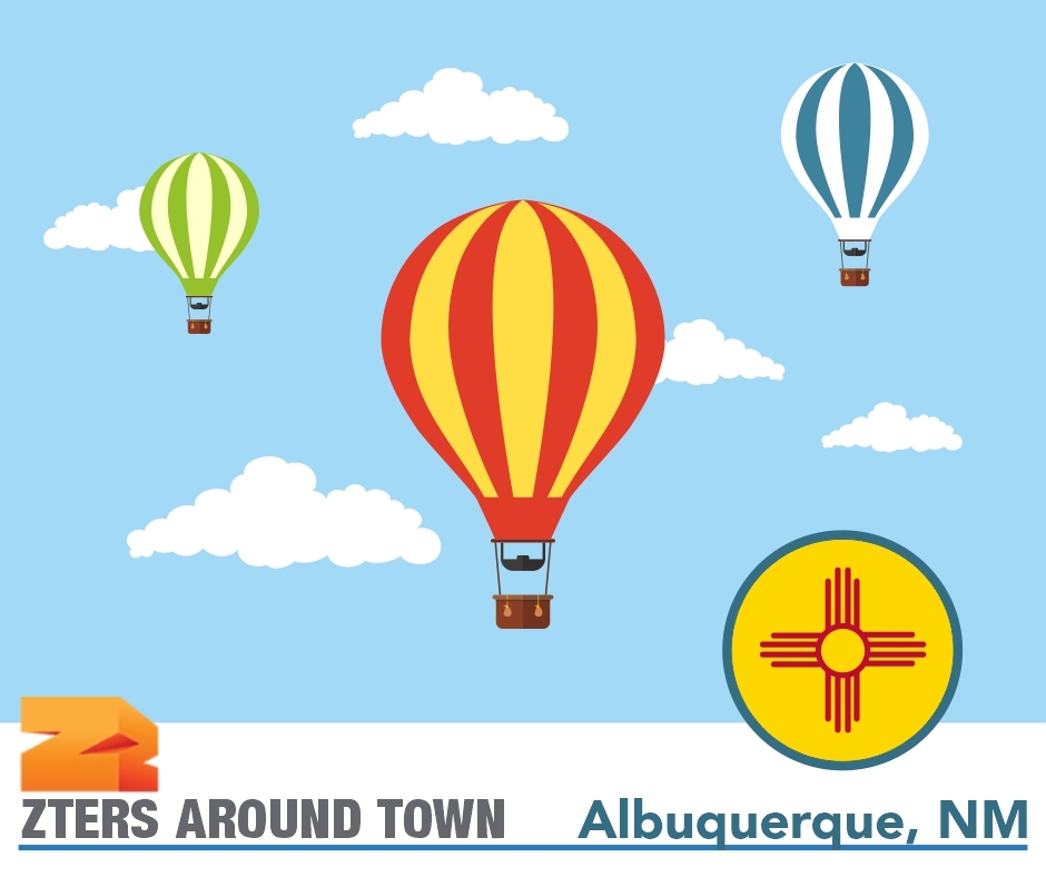 Albuquerque Balloon Fiesta depicted by 3 hot air balloons in different colors against a blue sky with clouds. ZTERS logo in bottom left.
