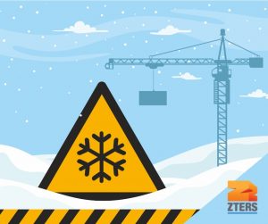 Winter construction safety tips depicted by yellow hazard symbol with snowflake inside in front of a snowy construction site.