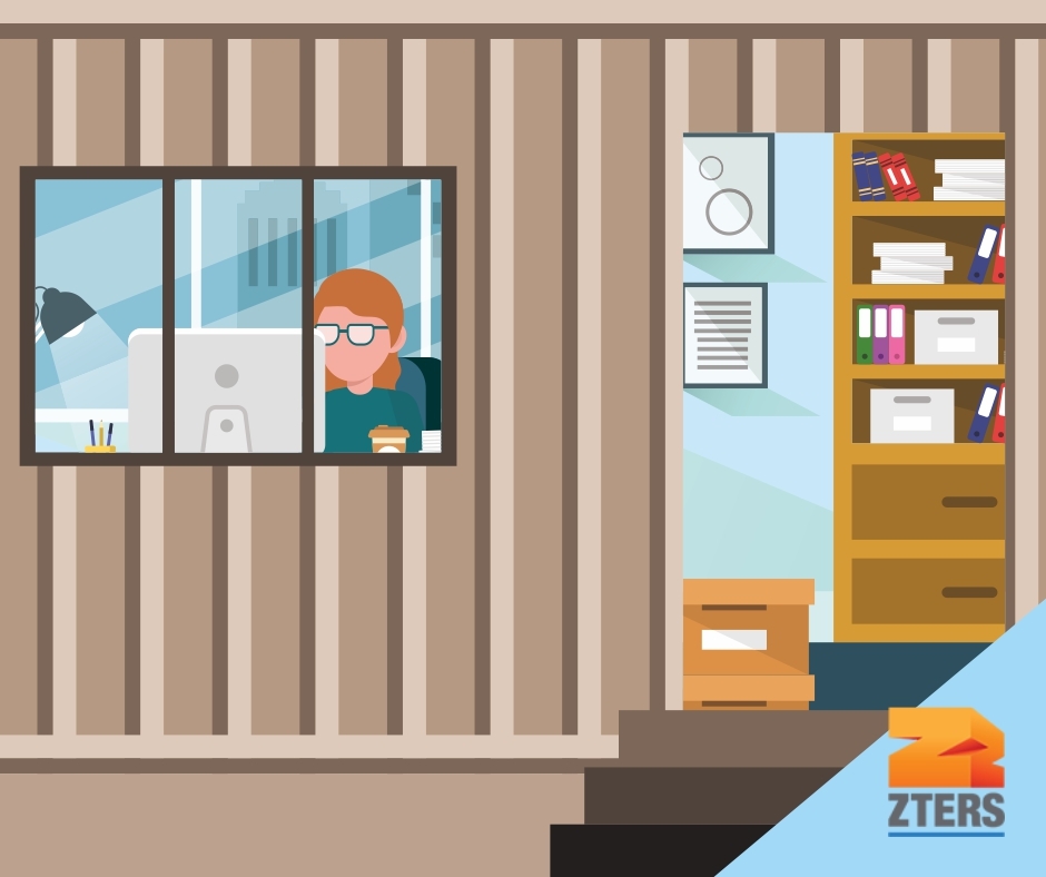 Mobile office setup depicted by a worker on their computer seen through a window of a converted storage container office. Files, wall art, and a shelf are seen inside. ZTERS logo in bottom right.