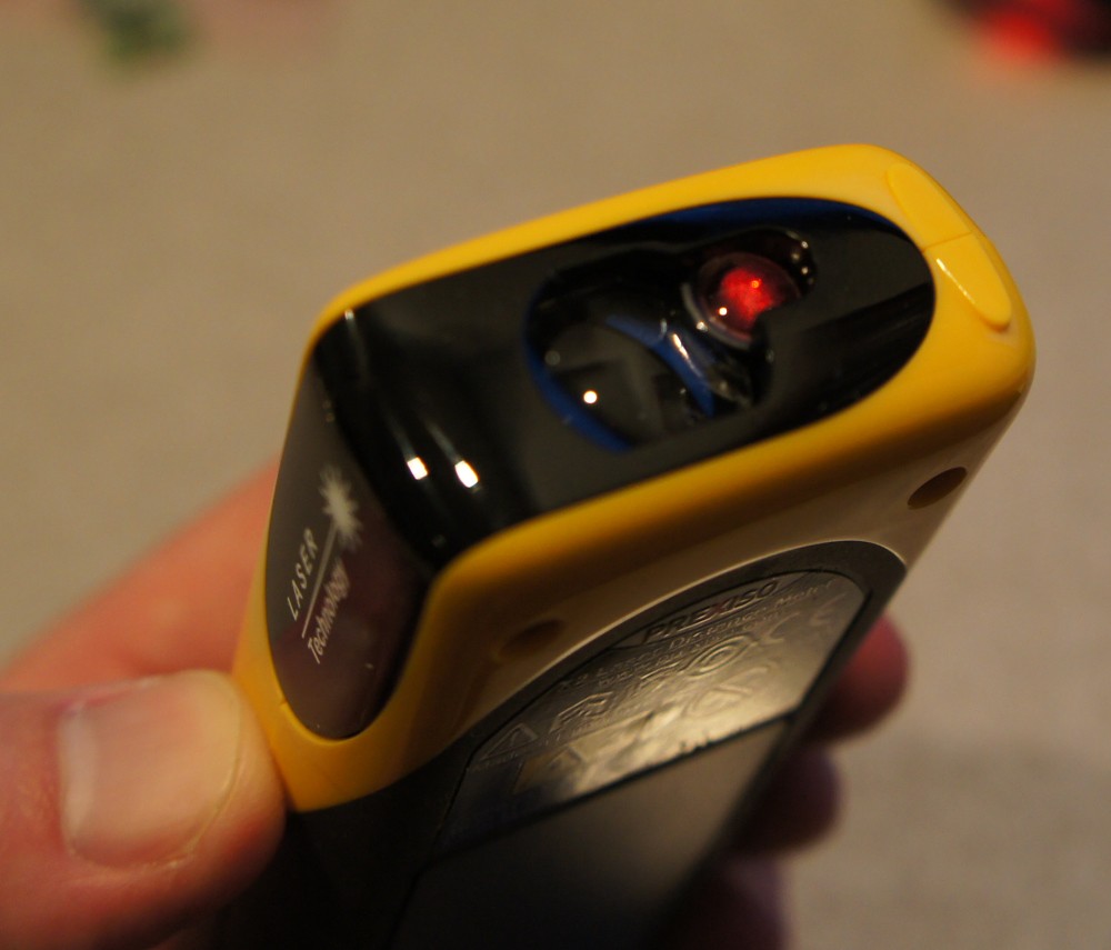 A picture of person holding a laser measuring tool.