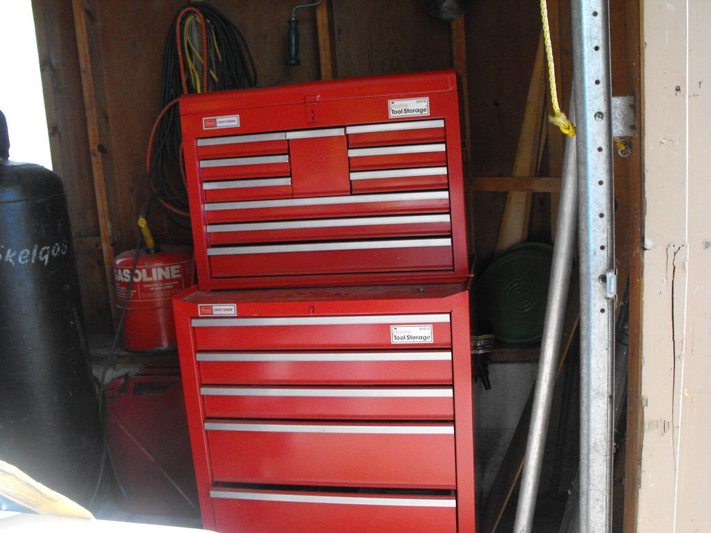 A picture of a red rolling toolchest in a garage.