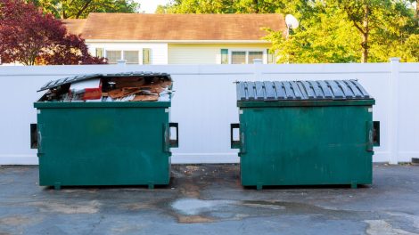 Side-by-side dumpsters showing how proper capacity planning can optimize waste management.